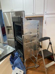 Kenmore electric oven is pulled out 